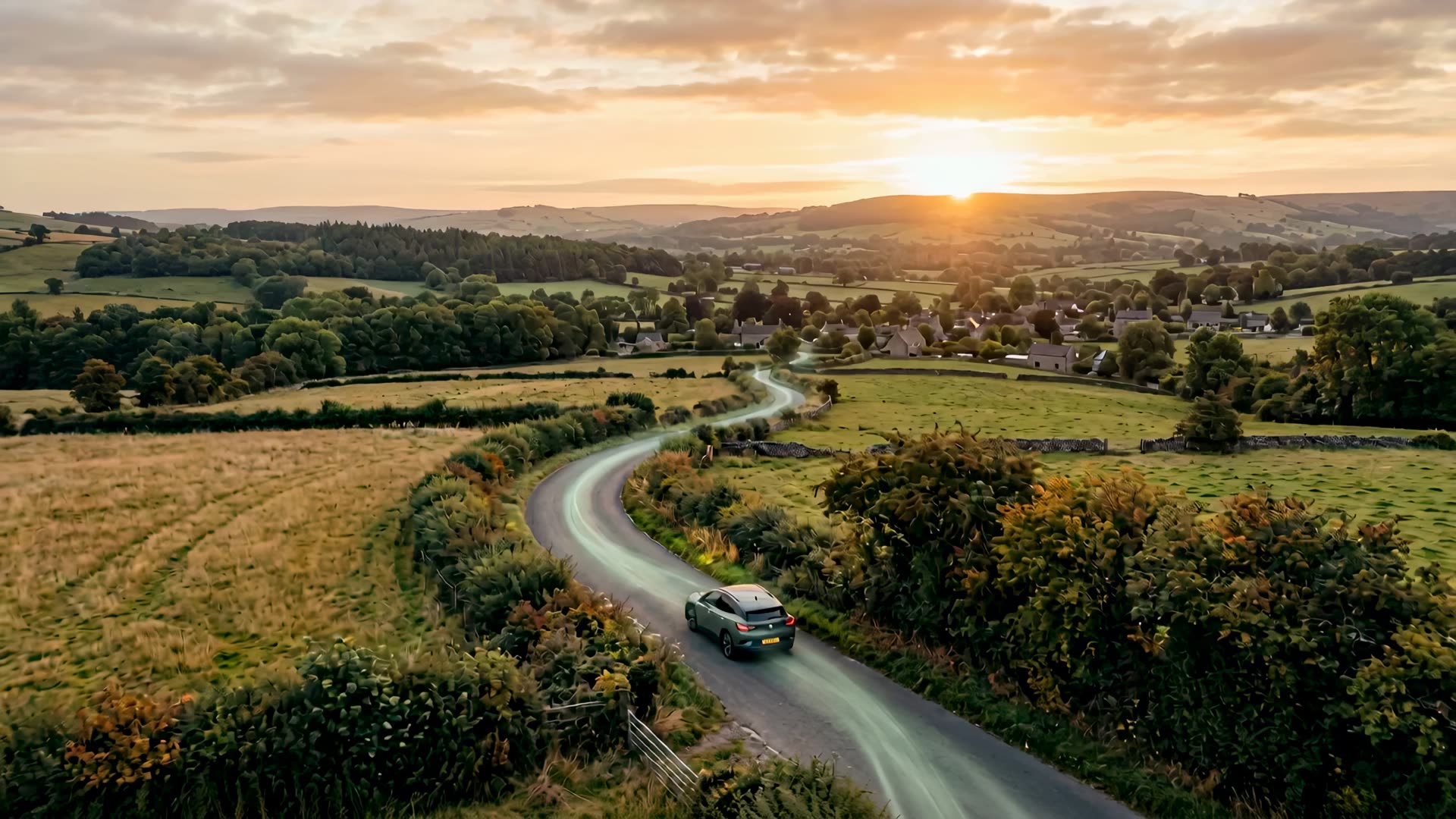 An EV on a winding country road at golden hour